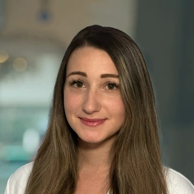 Dr. Danielle Riili-Mazniker smiling, she has brown hair.